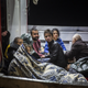 Refugees arriving at the port of Molivos on a fishing boat after their own boat sank in the Aegean. They were among 242 people rescued.